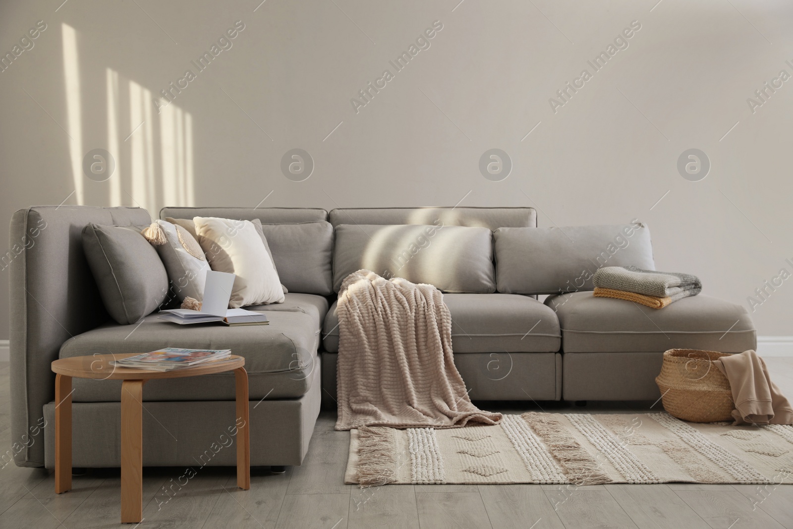 Photo of Living room interior with large grey sofa