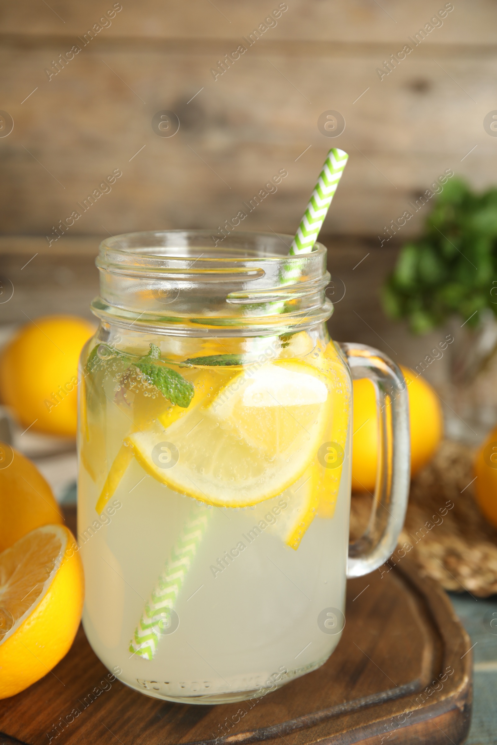 Photo of Cool freshly made lemonade in mason jar on table