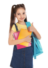 Little girl with school stationery on white background