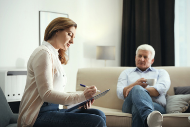 Photo of Professional psychotherapist working with patient in office