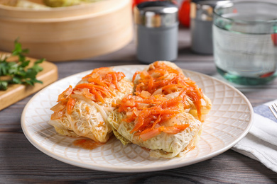 Photo of Delicious cabbage rolls on wooden table, closeup