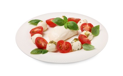 Photo of Plate of tasty Caprese salad with mozzarella, tomatoes, basil and pesto sauce isolated on white