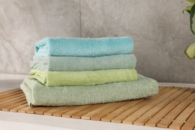 Photo of Stack of clean towels on countertop in laundry room