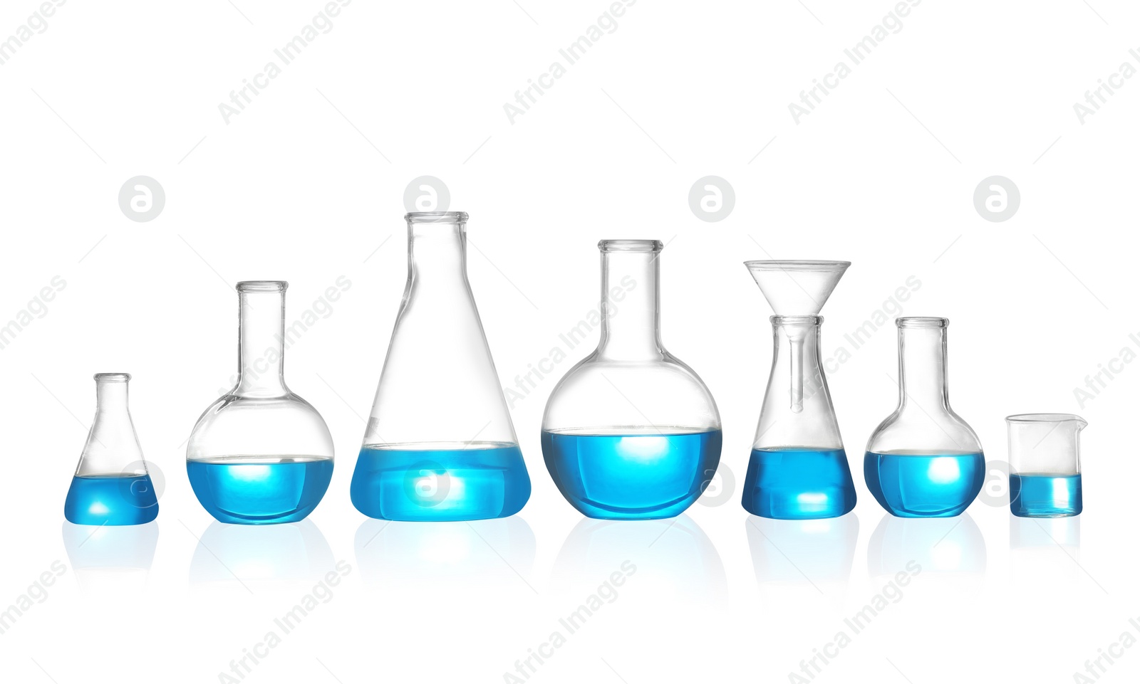 Photo of Laboratory glassware with liquid on white background. Solution chemistry