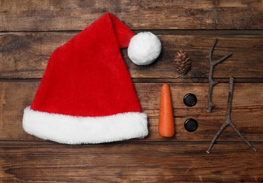 Set of elements for snowman on wooden background, flat lay