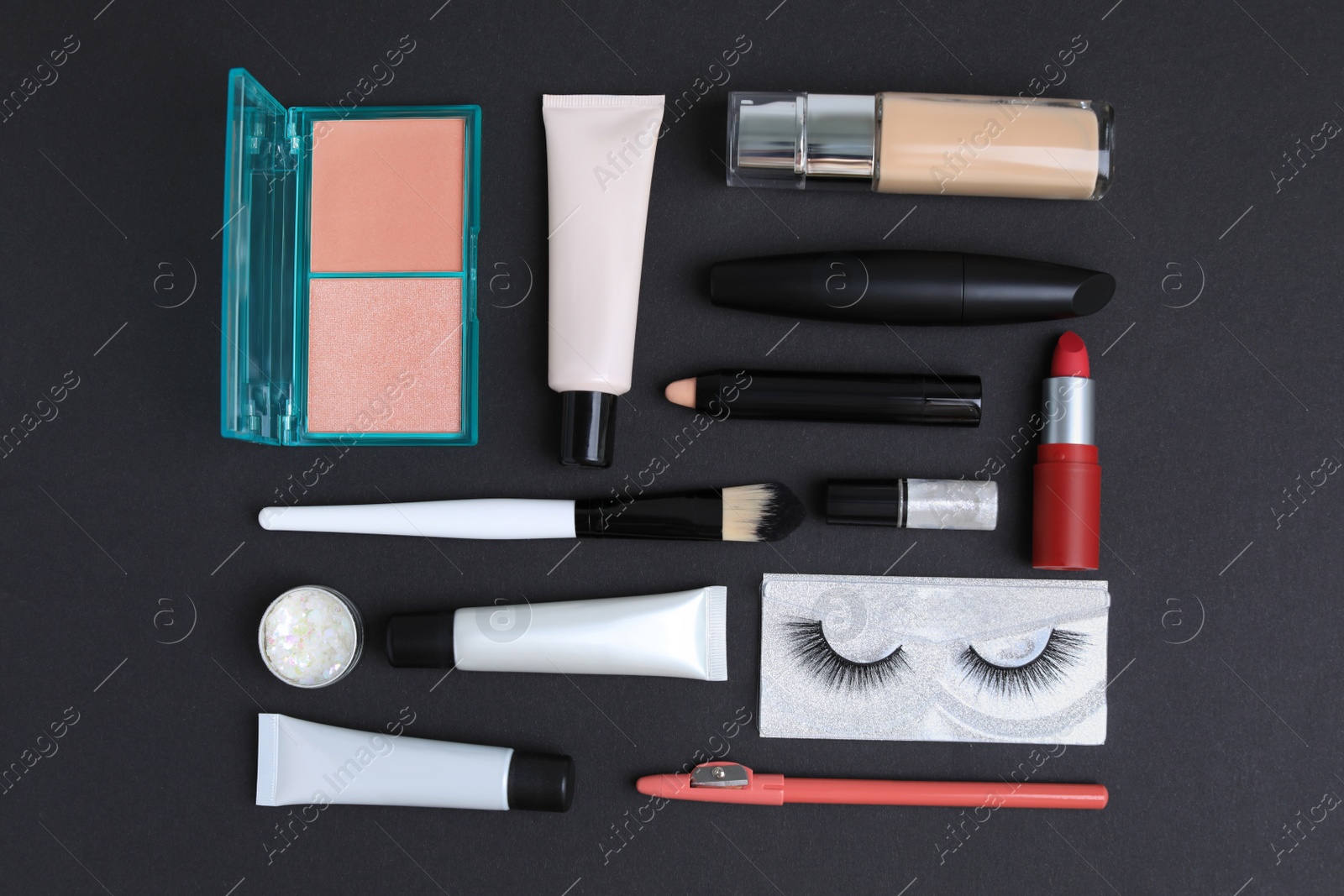 Photo of Set of makeup products on black background, flat lay