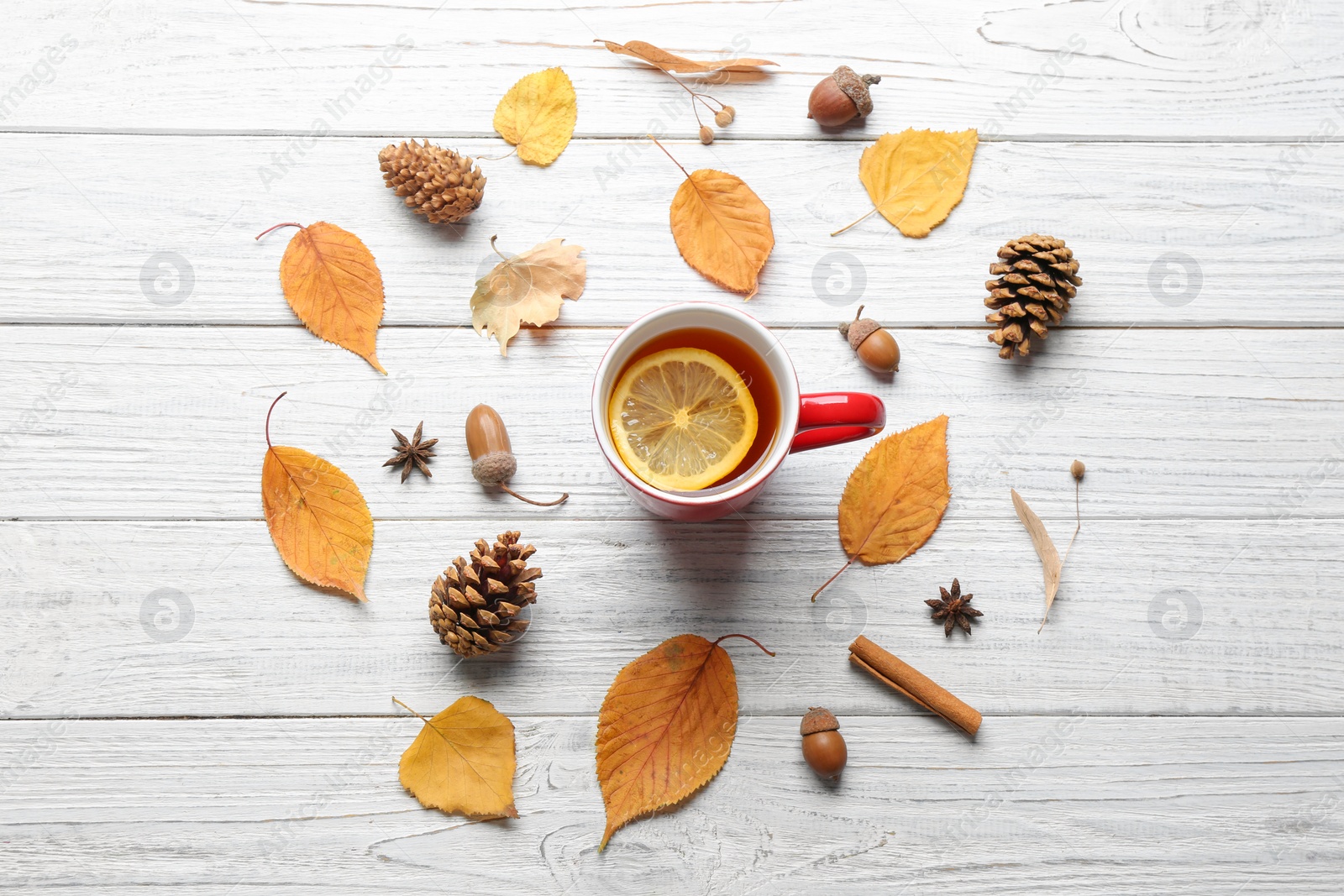 Photo of Flat lay composition with cup of hot drink on white wooden table. Cozy autumn atmosphere