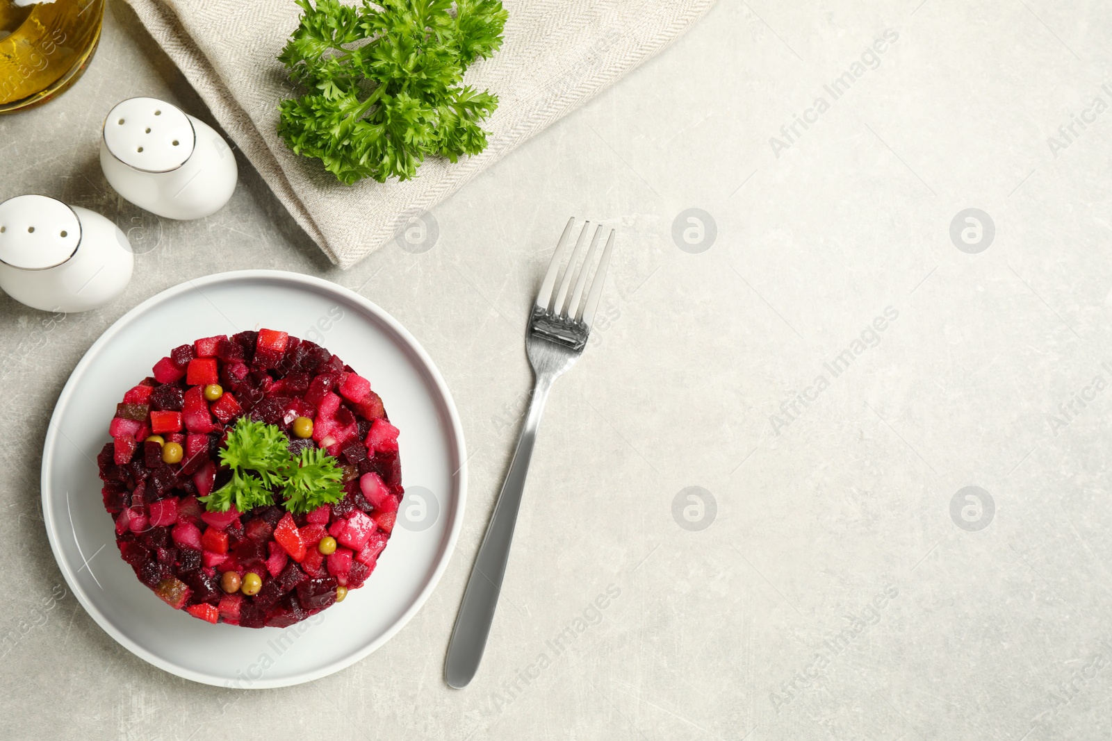 Photo of Traditional Russian salad vinaigrette served on light grey table, flat lay. Space for text