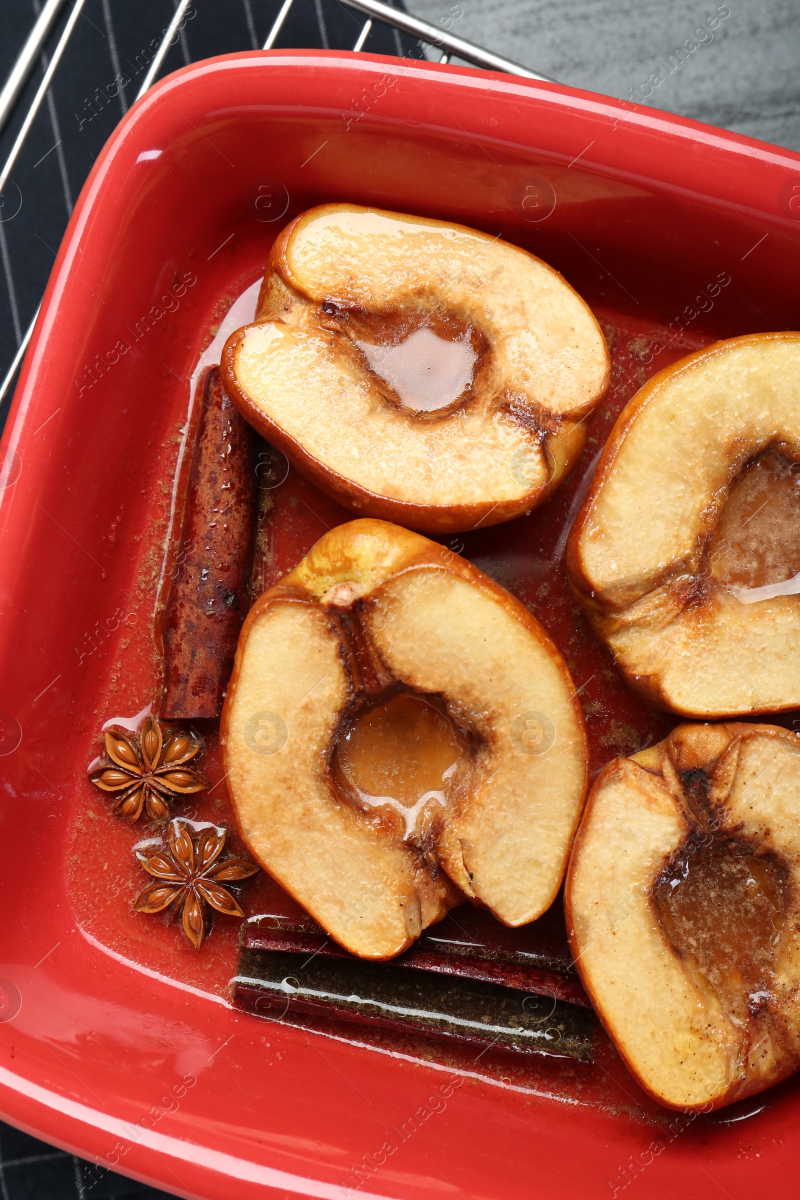 Photo of Tasty baked quinces with anise and honey in dish on table, top view