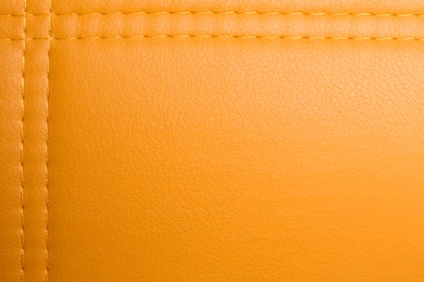 Photo of Texture of orange leather as background, top view