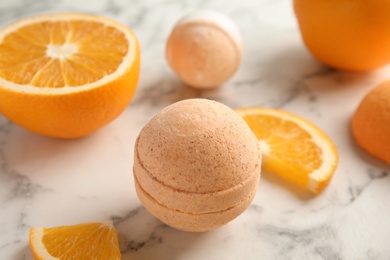 Photo of Bath bomb and orange slices on marble table