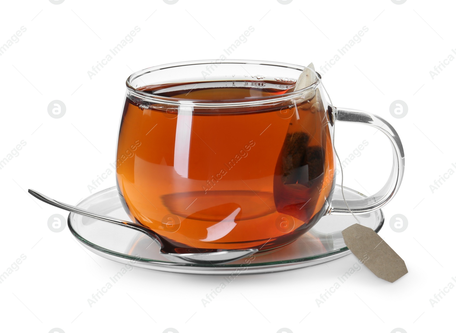 Photo of Brewing aromatic tea. Cup with teabag and spoon isolated on white