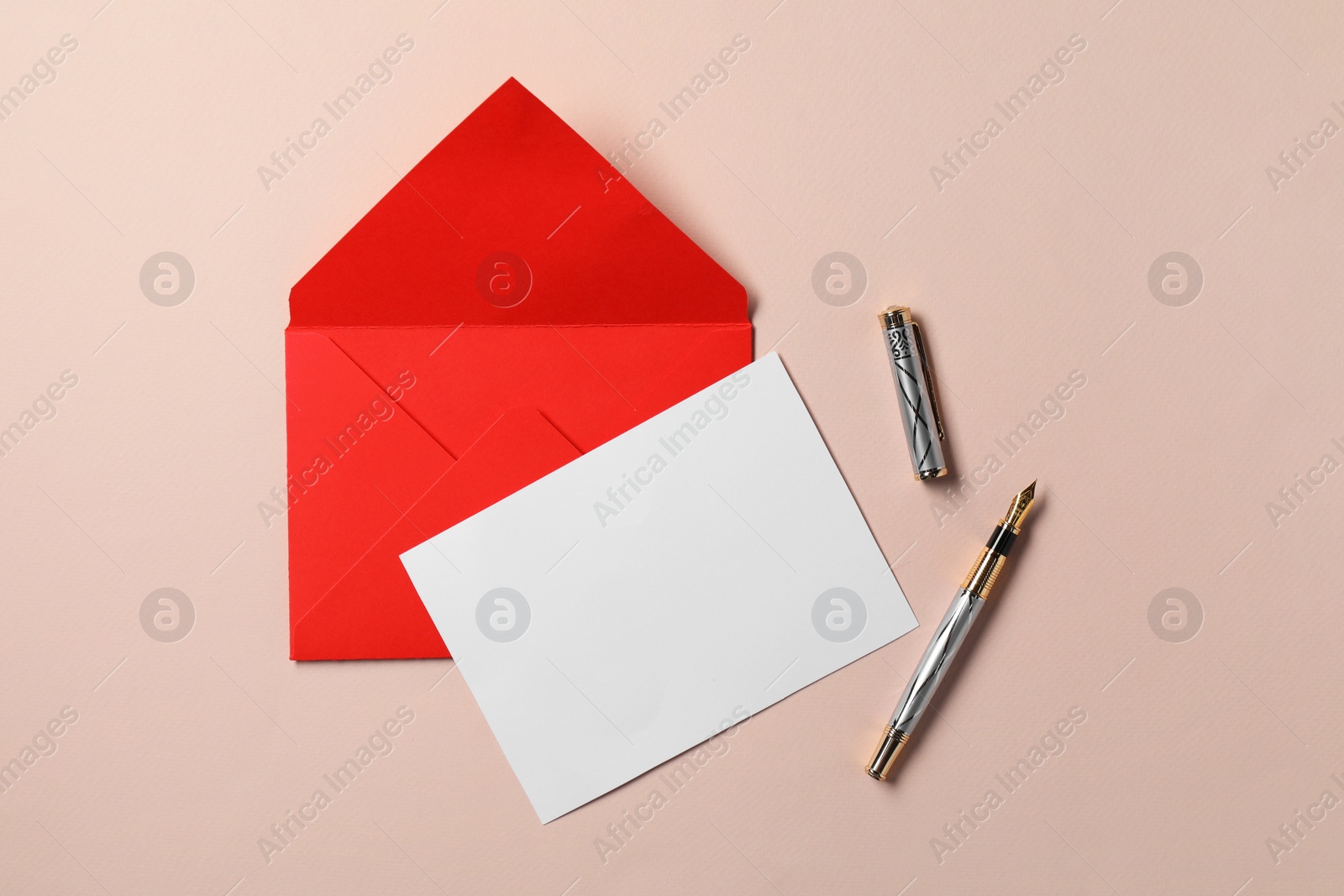 Photo of Blank sheet of paper, letter envelope and pen on beige background, top view. Space for text