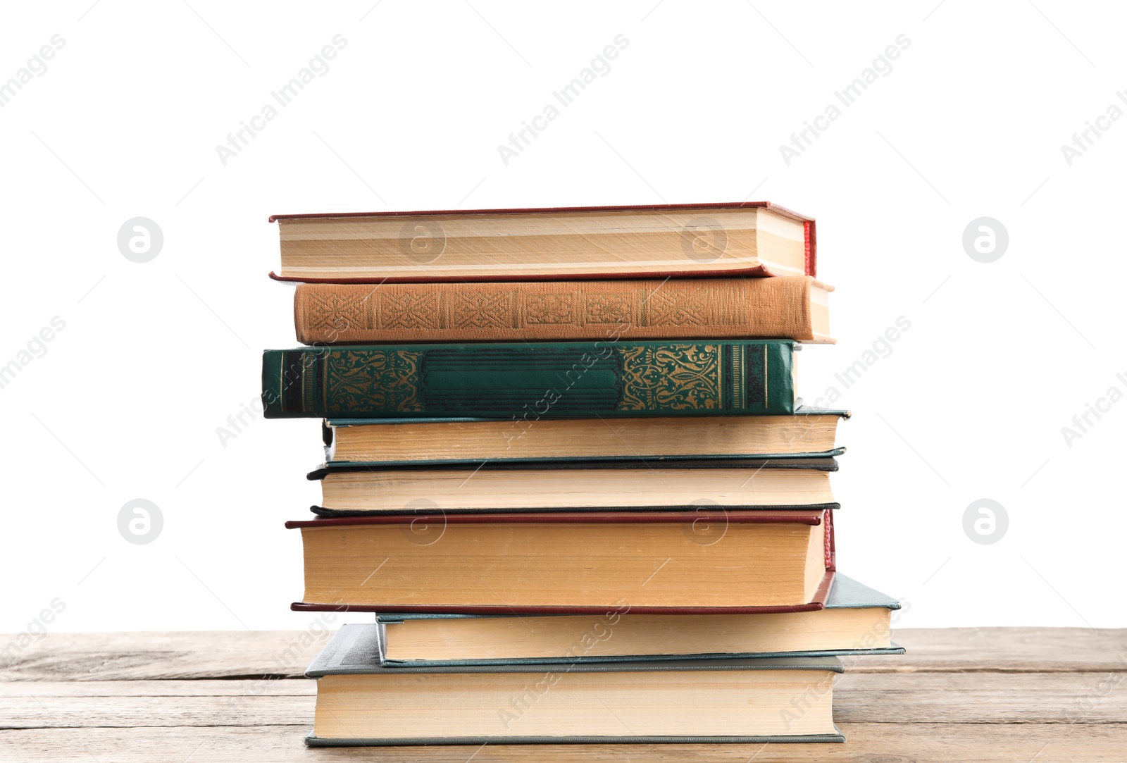 Photo of Stack of old vintage books on wooden table against white background