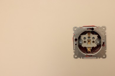 Photo of Disassembled socket on white wall, space for text