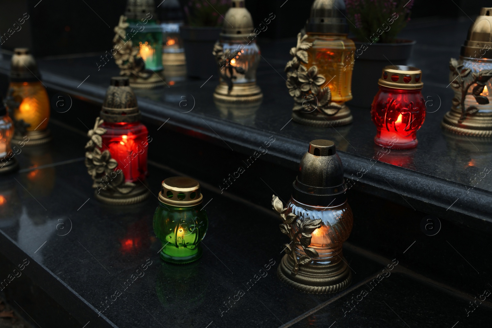 Photo of Grave lights on granite surface at cemetery