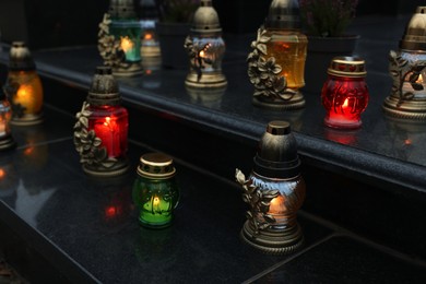 Photo of Grave lights on granite surface at cemetery