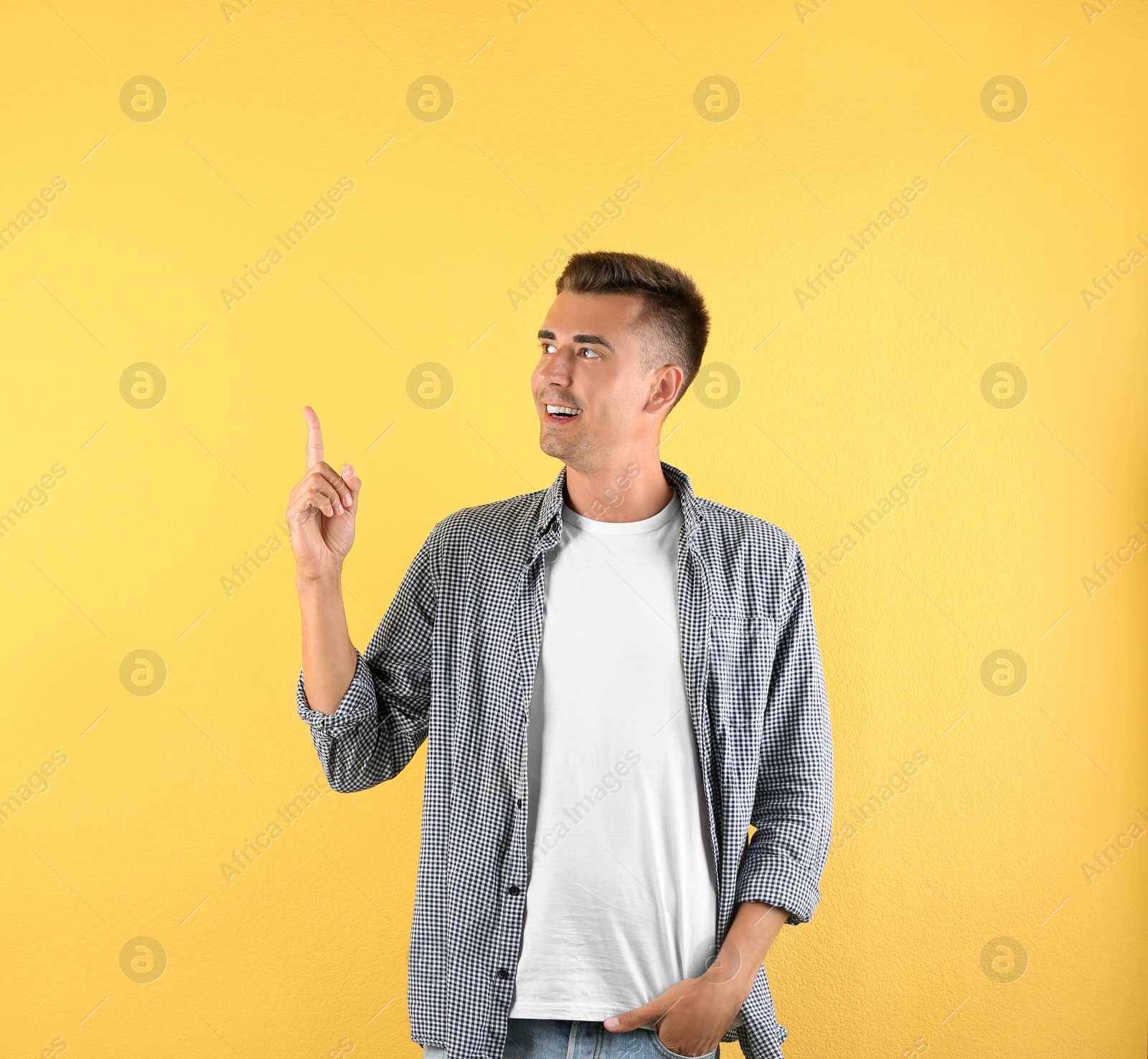 Photo of Handsome young man on color background