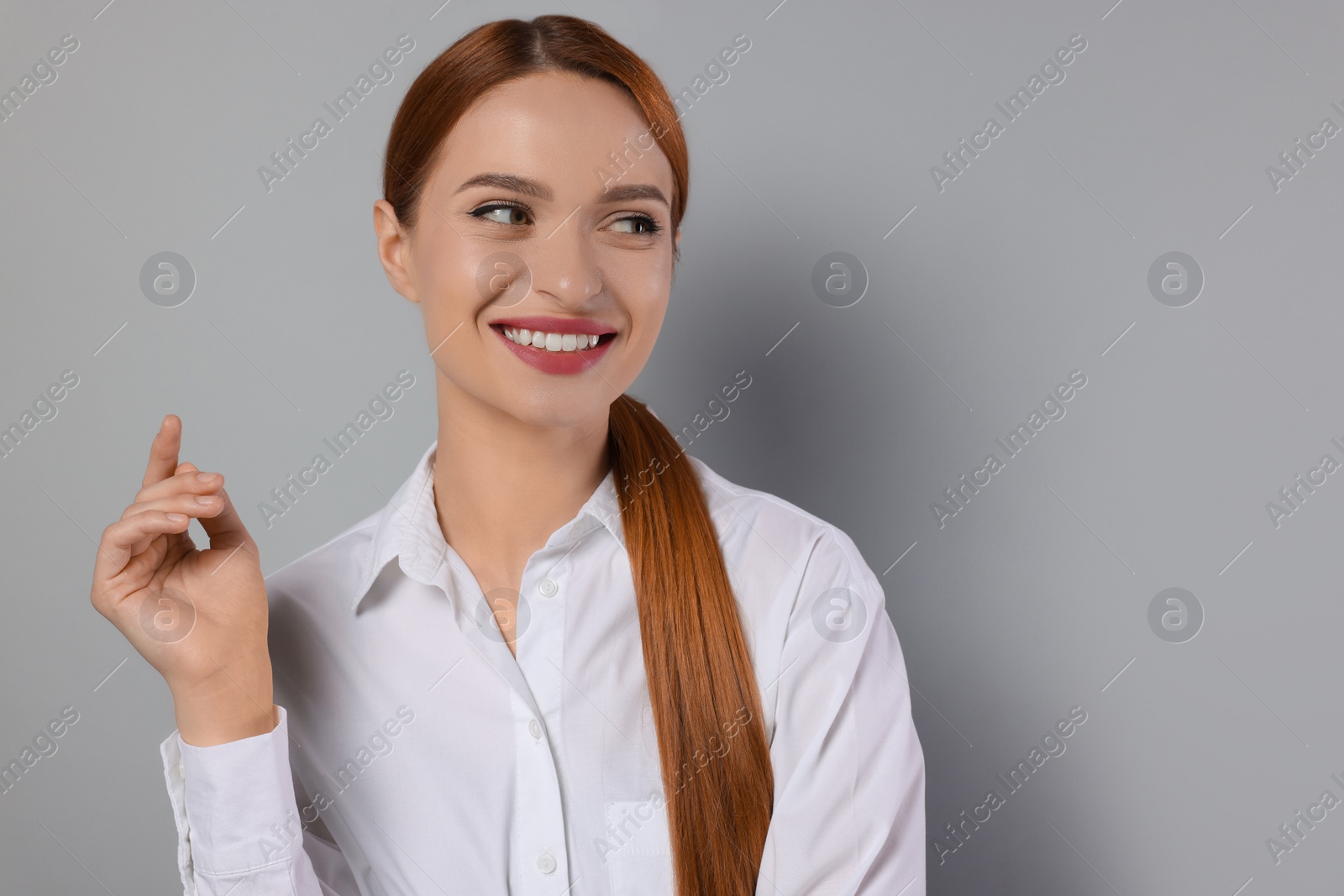 Photo of Portrait of beautiful young woman on light gray background