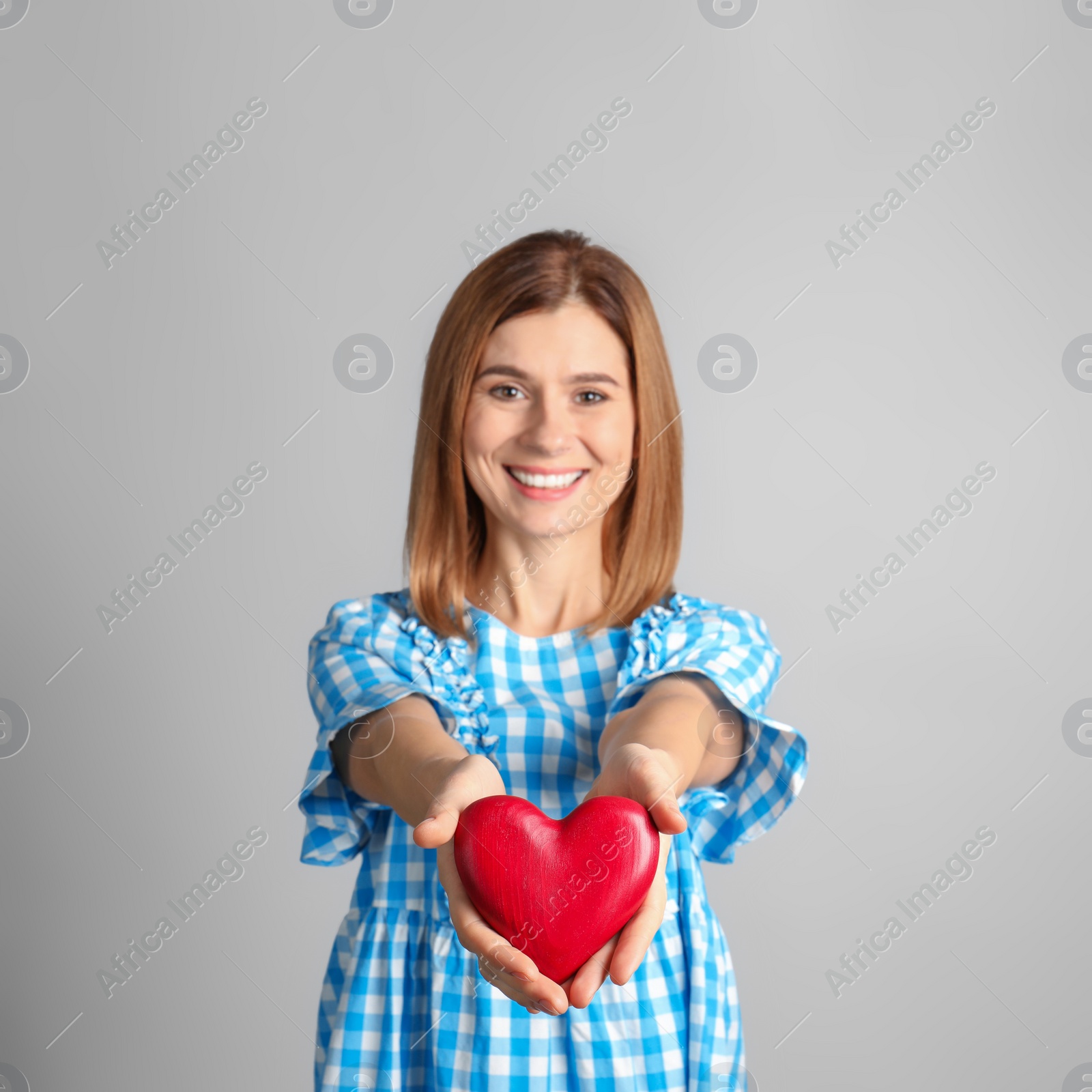 Photo of Portrait of woman with decorative heart on color background