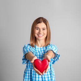 Photo of Portrait of woman with decorative heart on color background