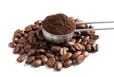 Photo of Scoop with coffee grounds and roasted beans on white background