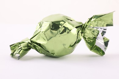 Candy in light green wrapper isolated on white