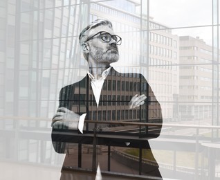 Double exposure of businessman and cityscape with office buildings