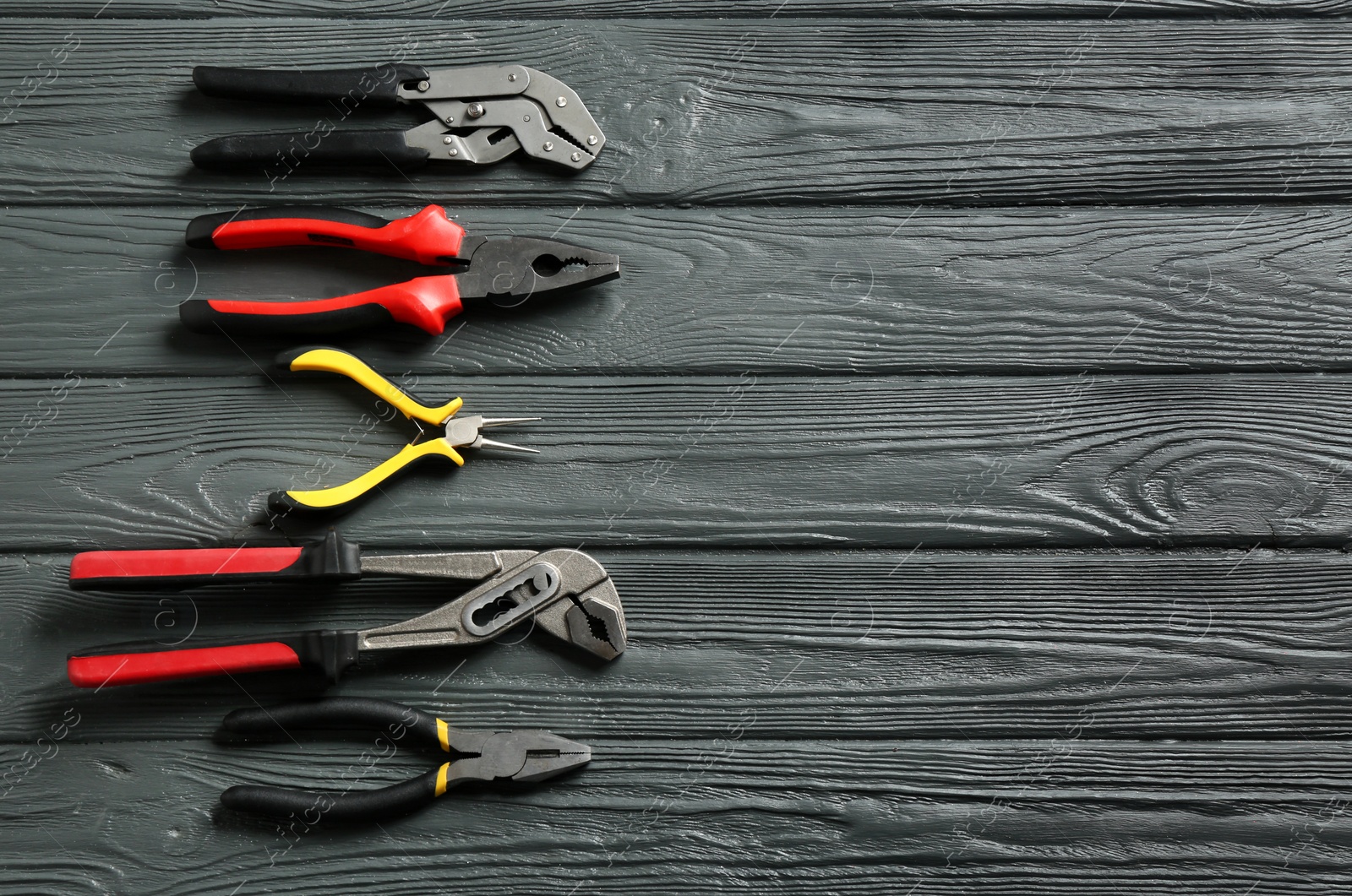 Photo of Flat lay composition with plumber's tools and space for text on wooden background