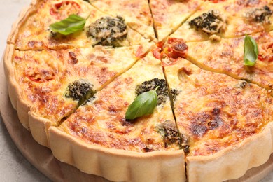 Delicious homemade vegetable quiche on table, closeup