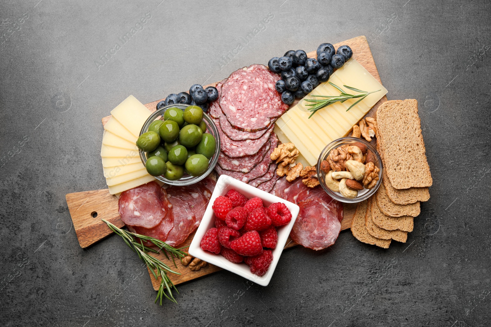 Photo of Snack set with delicious Parmesan cheese on grey table, top view