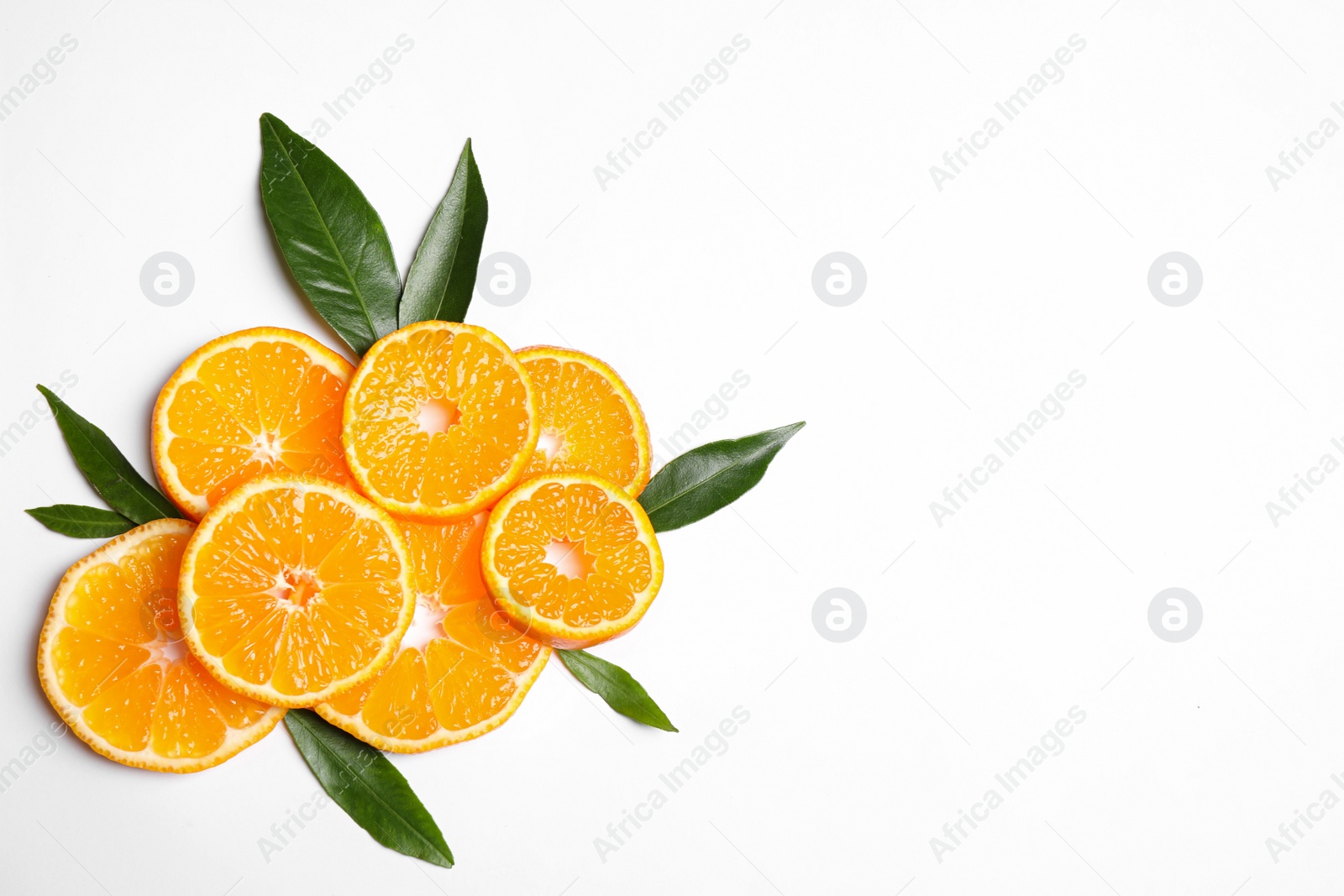 Photo of Composition with slices of fresh ripe tangerines and leaves on white background, top view. Citrus fruit