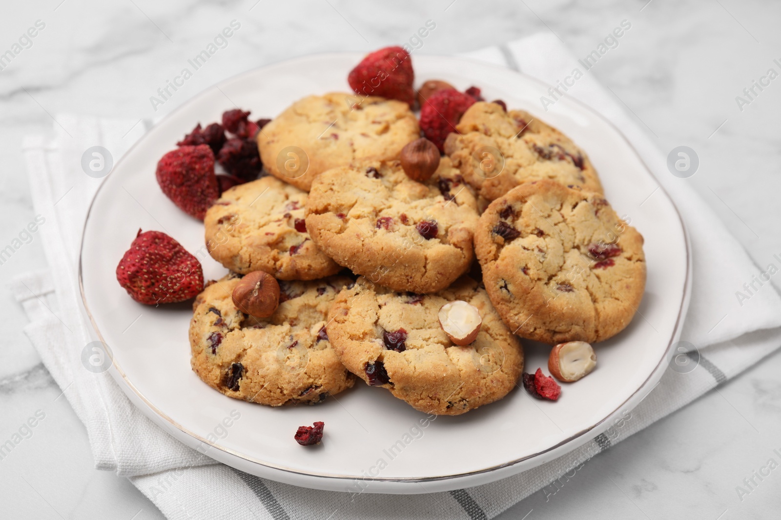 Cookies with freeze dried fruits and nuts on white marble table, closeup Photo of Cookies with freeze dried fruits and nuts on white marble table, closeup