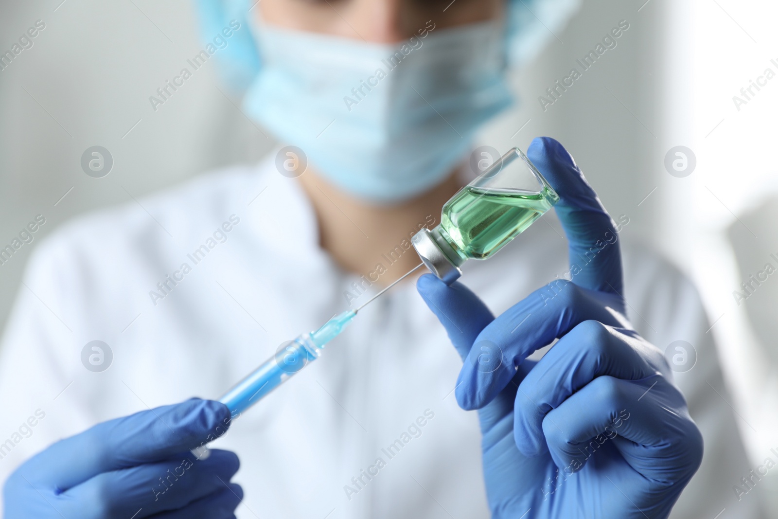 Photo of Doctor filling syringe with medication in clinic, closeup. Vaccination and immunization