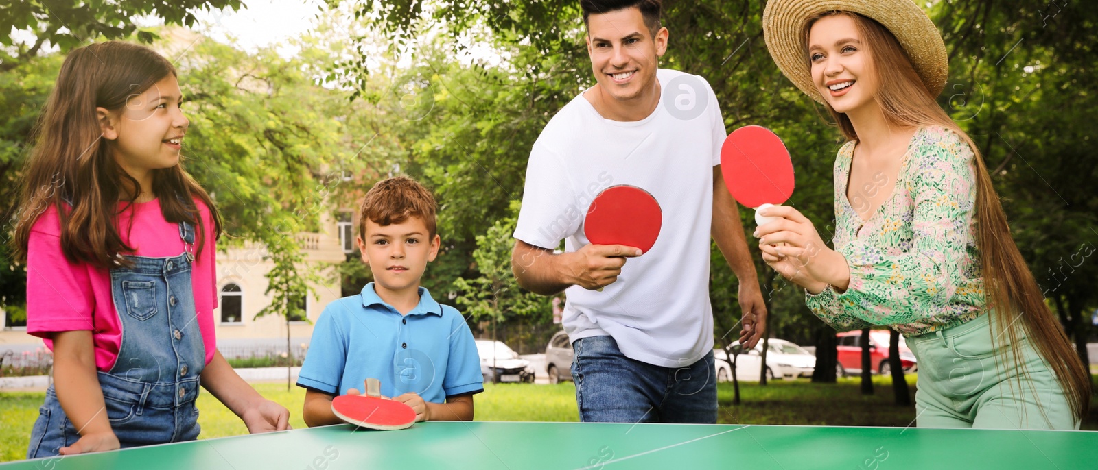 Image of Happy family playing ping pong in park. Banner design