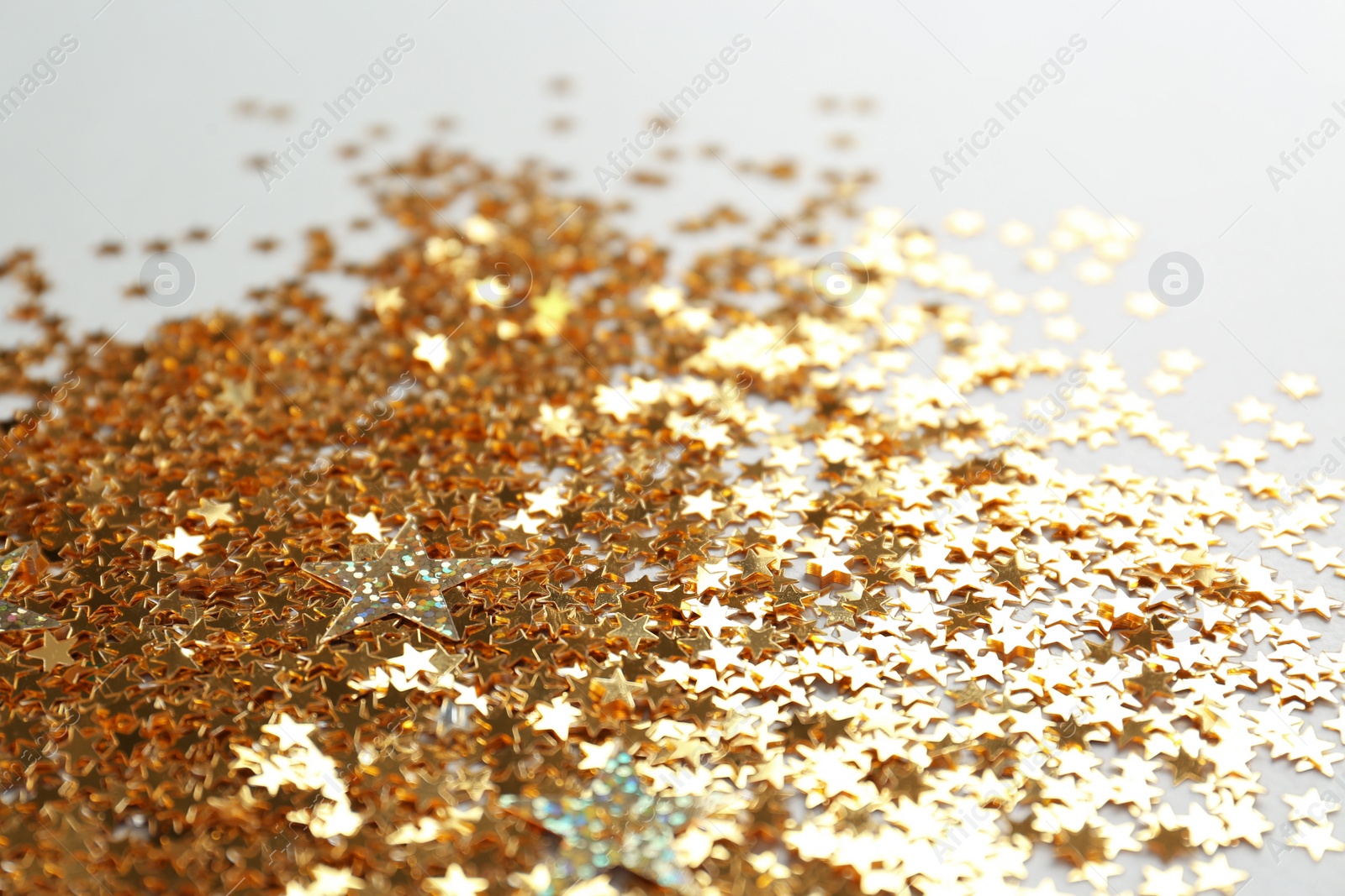 Photo of Confetti stars on white background, closeup. Christmas celebration