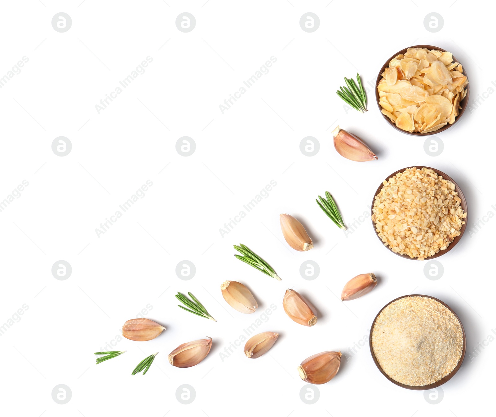 Photo of Cloves, rosemary and bowls with different dried garlic on white background