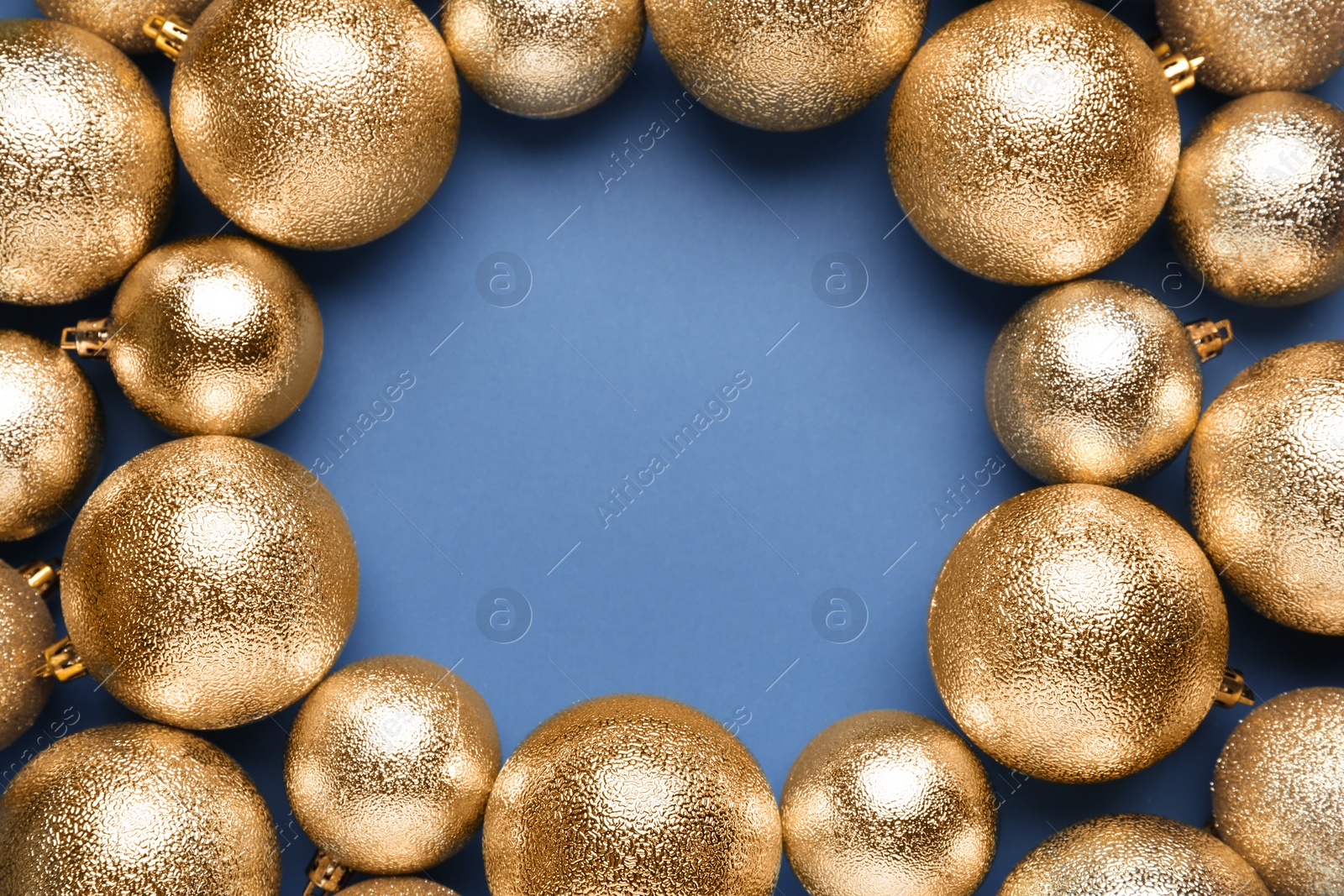 Photo of Frame of shiny Christmas balls on blue background, flat lay. Space for text