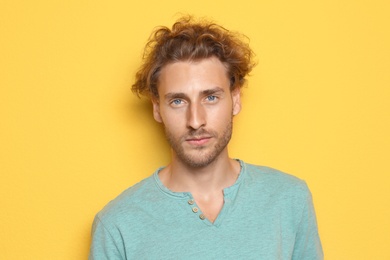 Portrait of young man on color background