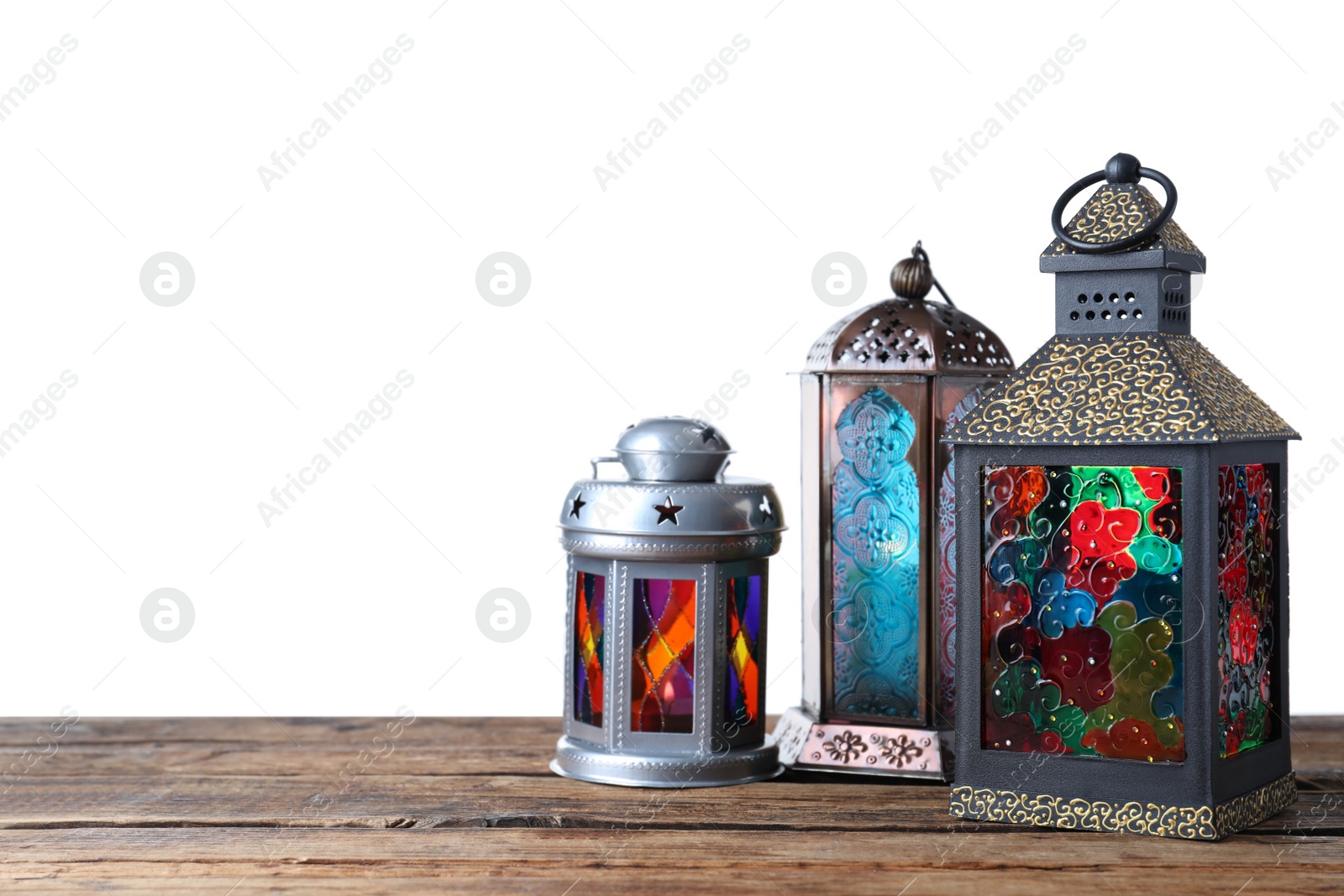 Photo of Decorative Arabic lanterns on wooden table against white background