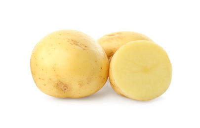 Photo of Whole and cut fresh raw organic potatoes on white background