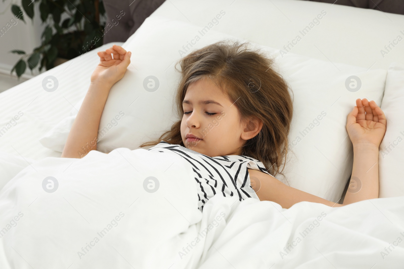 Photo of Cute little girl sleeping in comfort bed
