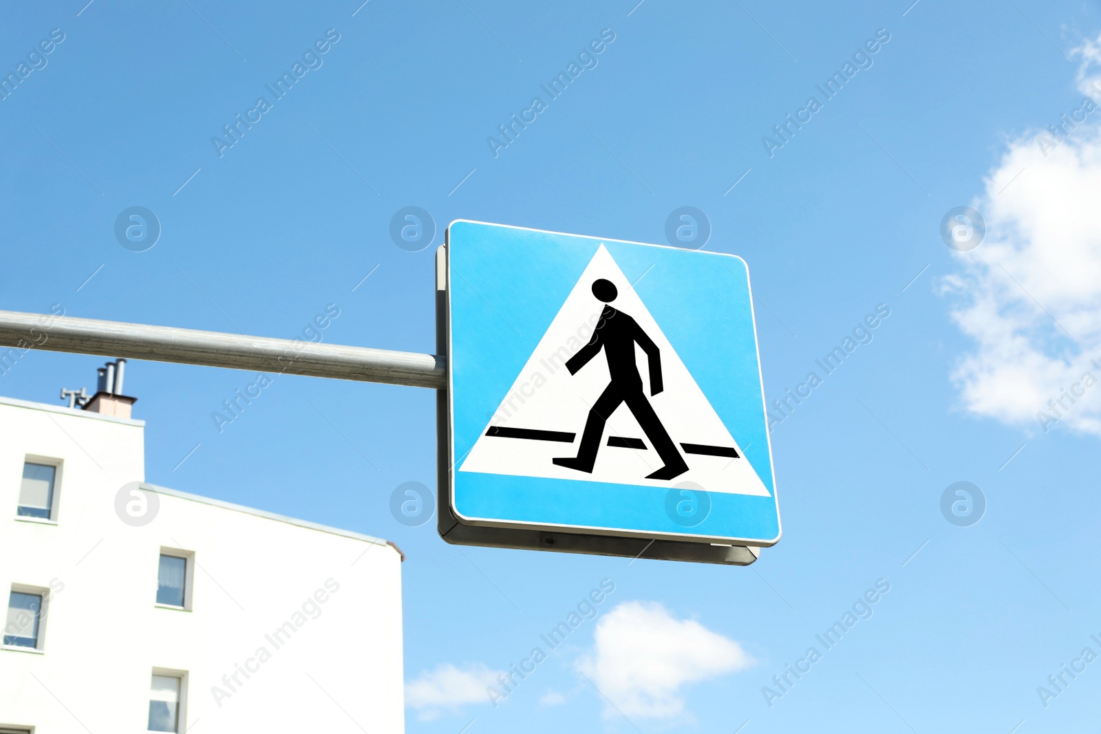 Photo of Traffic sign Pedestrian Crossing on city street, low angle view
