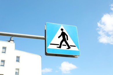 Photo of Traffic sign Pedestrian Crossing on city street, low angle view