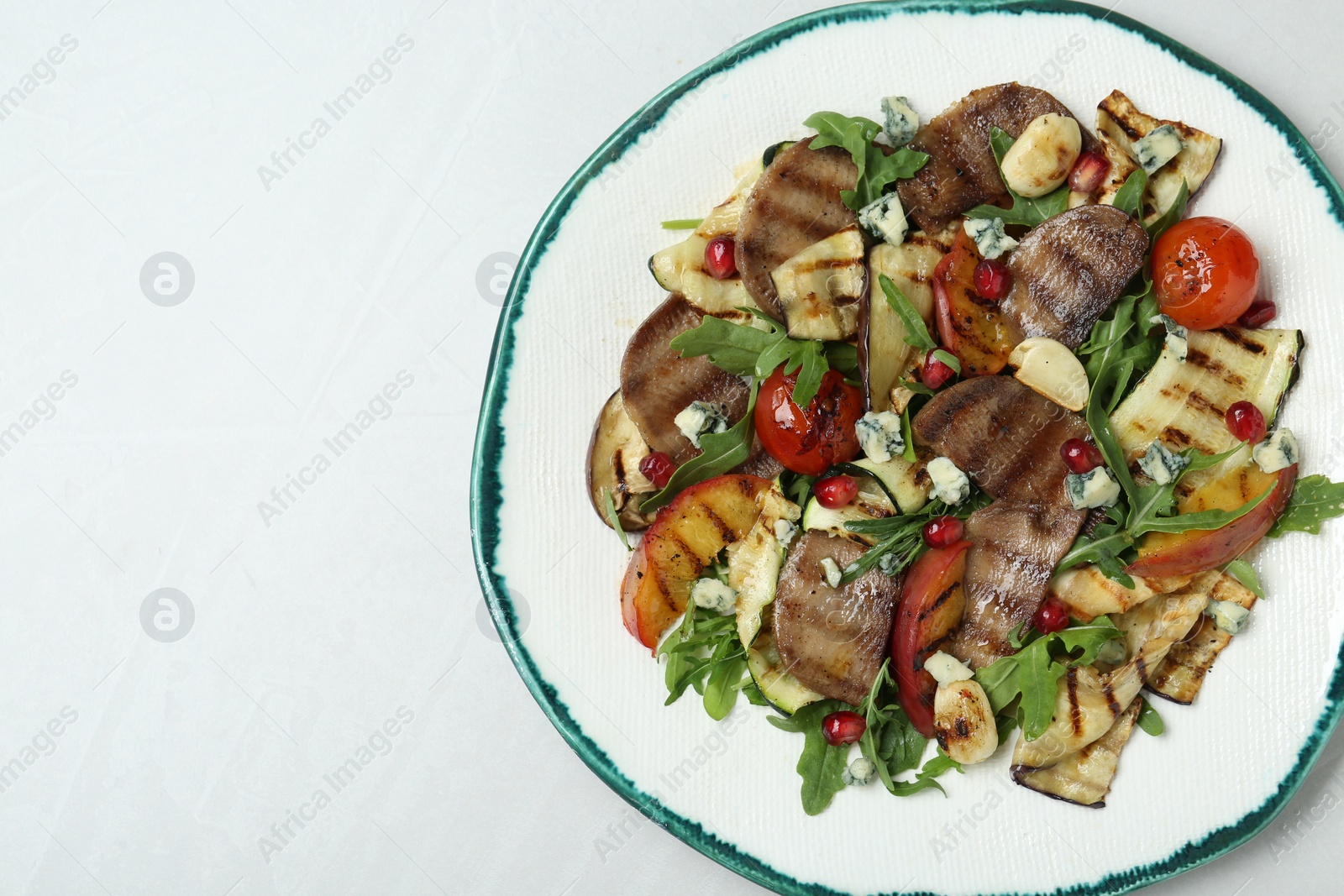 Photo of Delicious salad with beef tongue, grilled vegetables, peach and blue cheese on white table, top view. Space for text