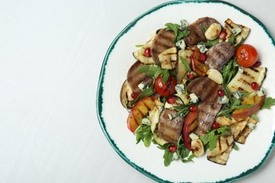 Delicious salad with beef tongue, grilled vegetables, peach and blue cheese on white table, top view. Space for text