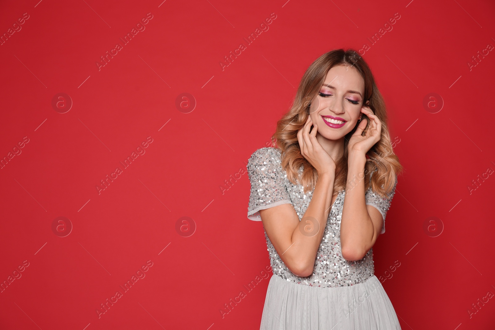 Photo of Happy woman in stylish dress on red background, space for text. Christmas party