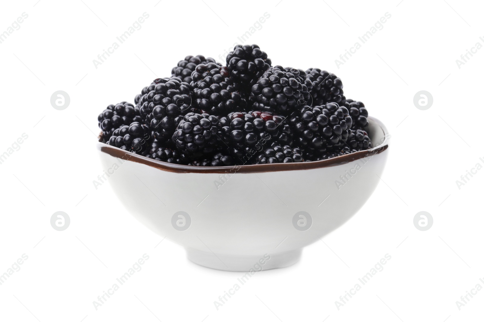 Photo of Ceramic bowl of tasty ripe blackberries on white background