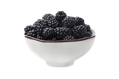 Photo of Ceramic bowl of tasty ripe blackberries on white background