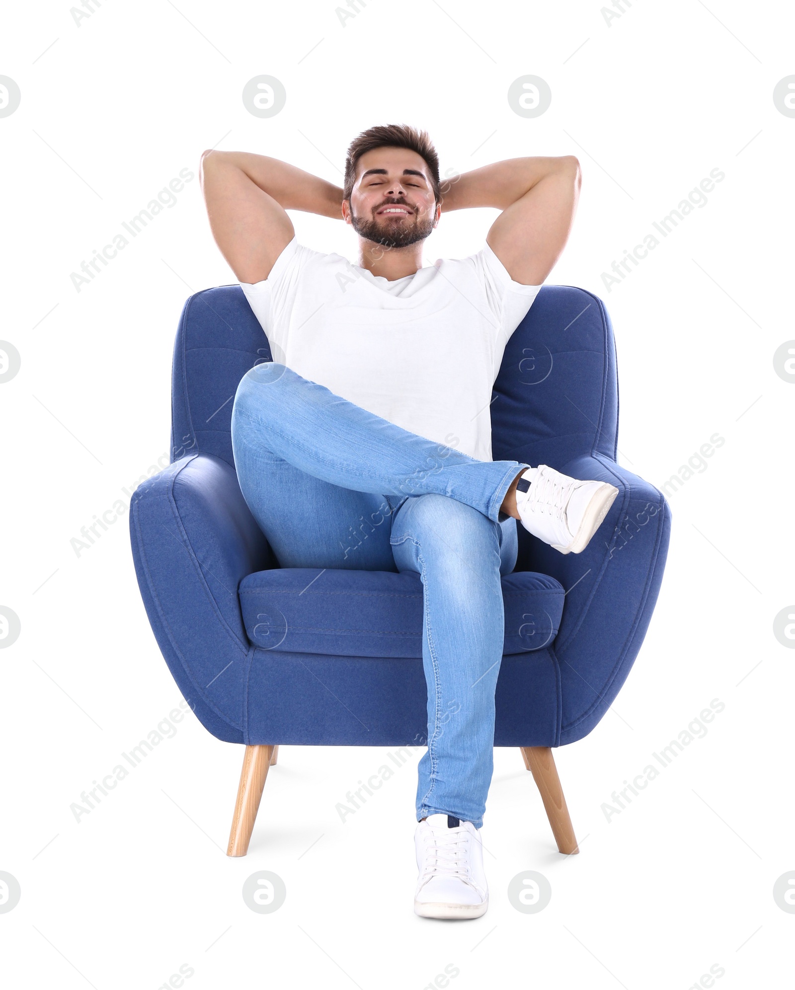 Photo of Young man resting in armchair isolated on white